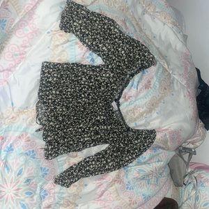 black blouse with a pink and yellow floral design